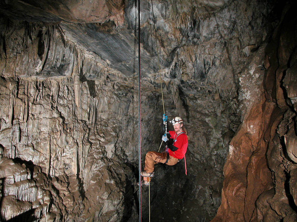 A person rappells in Moaning Caverns.
