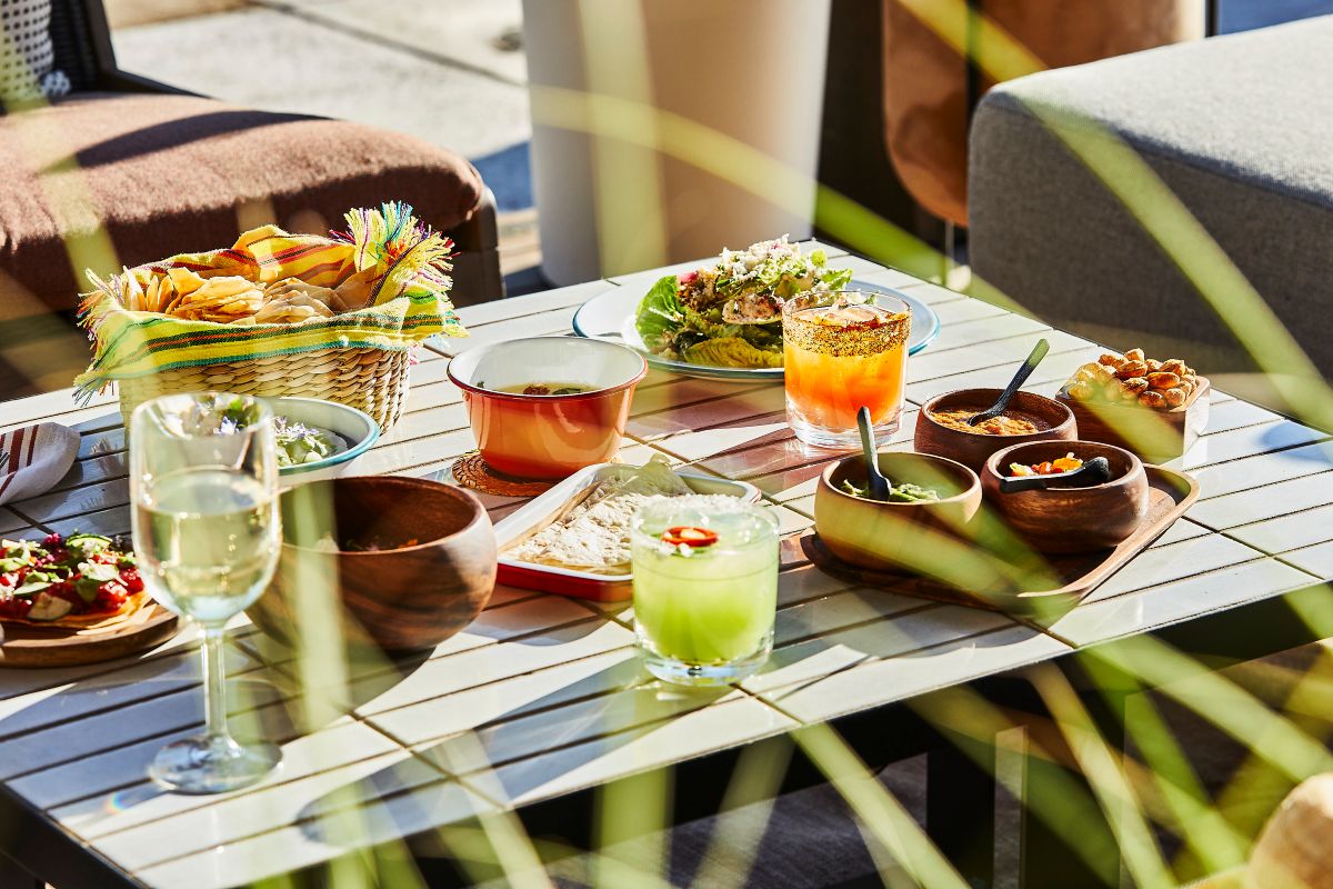 table sits laiden with cocktails and food as part of an exclsuive culinary experience in the Solage