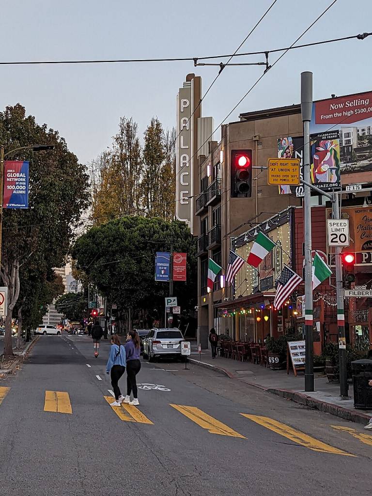 A San Francisco street with a Palace Theater sign.