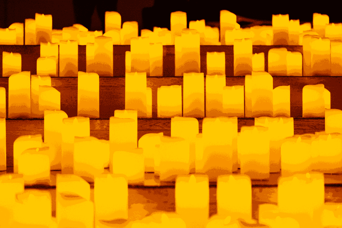 Thousands of candles scattered around the floor at a Candlelight event