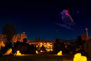 Illuminated drones fly over a string quartet