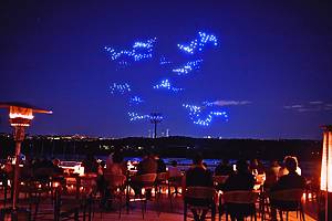 Illuminated drones fly over a string quartet