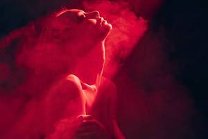 A woman in red light