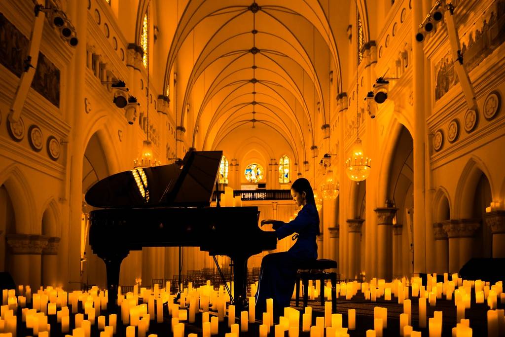 A pianist performing at CHIJMES Hall in Singapore for a Candlelight concert
