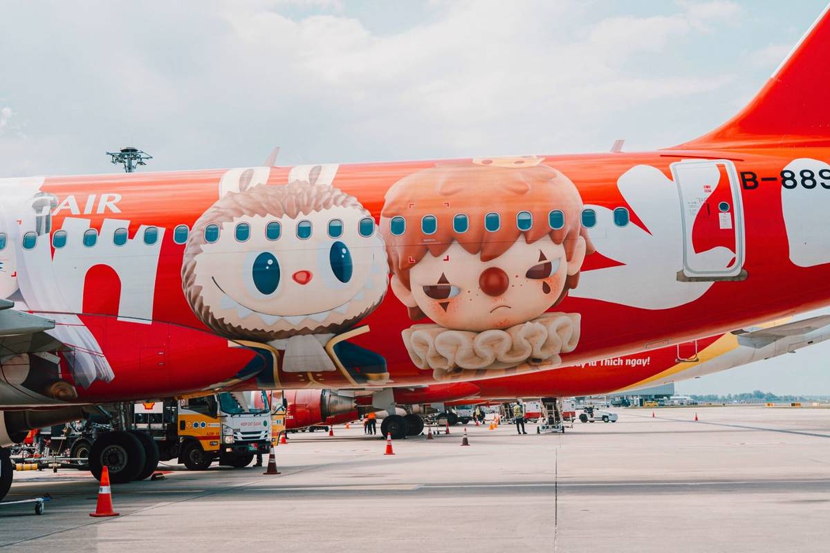Pop Mart red planes on tarmac at Changi Airport with characters on livery
