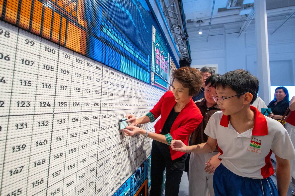 putting on bricks at LEGO exhibition