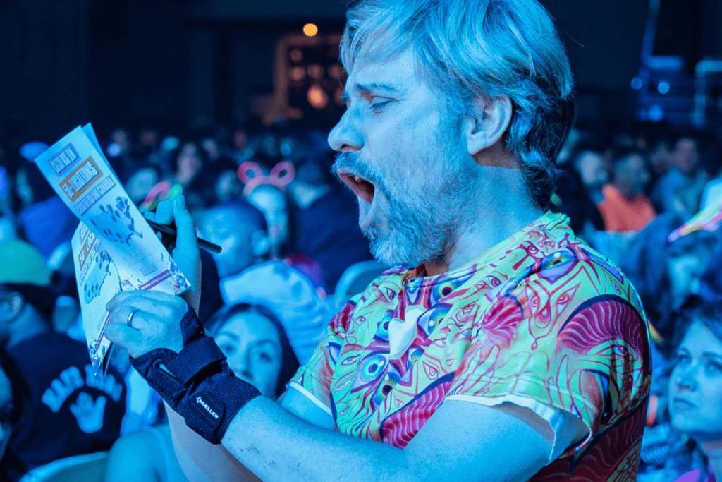 Man screaming something into microphone at a Bingo Loco event