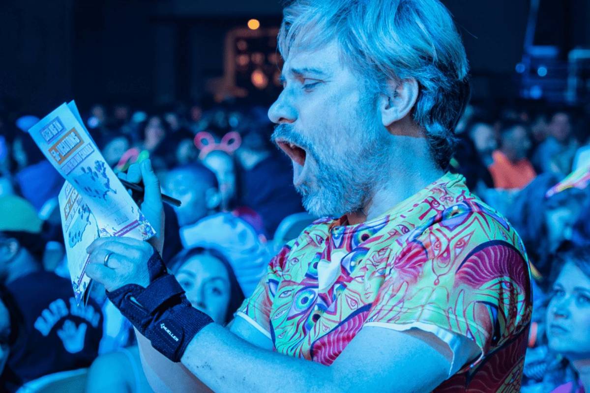 Man screaming something into microphone at a Bingo Loco event