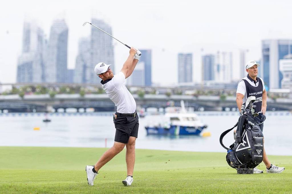 A golfer swinging at Sentosa Golf Course during the LIV Golf Singapore tournament