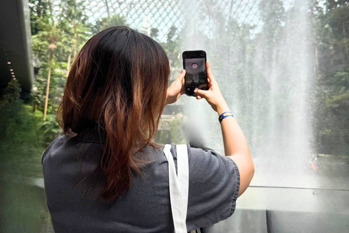 A participant taking a photo of the iconic waterfall at Jewel Changi Airport