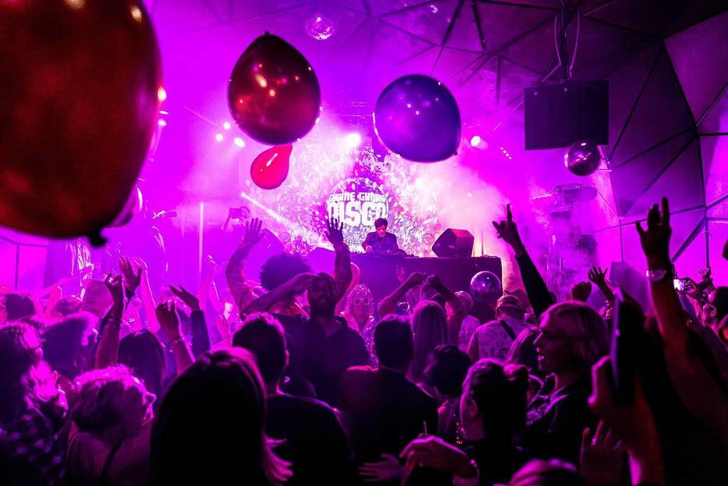 large room filled with people dancing at gimme gimme disco