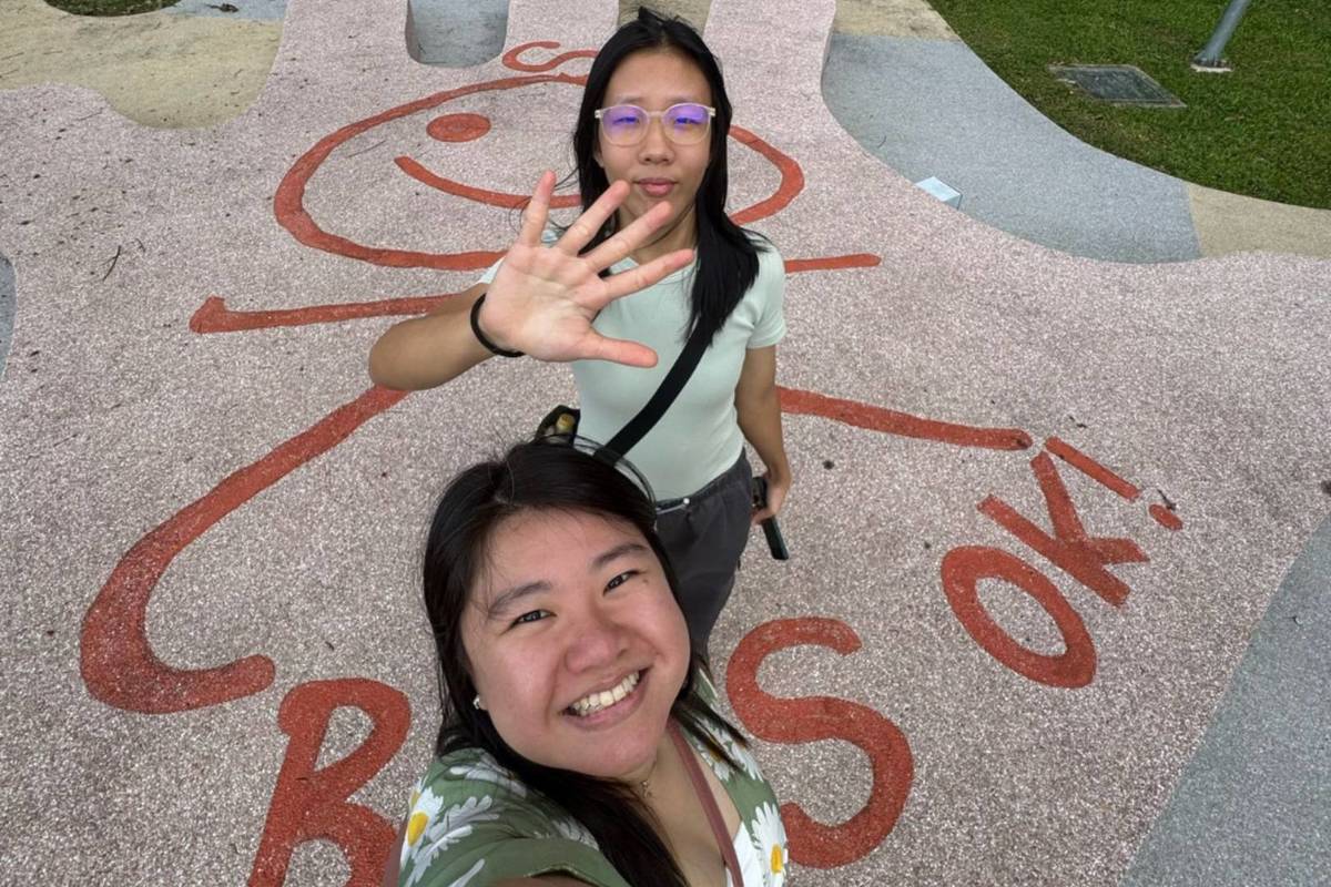Friends posing, smiling at Holland Village
