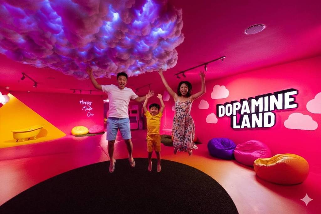 A family jumping in the air happily at Dopamine Land attractions