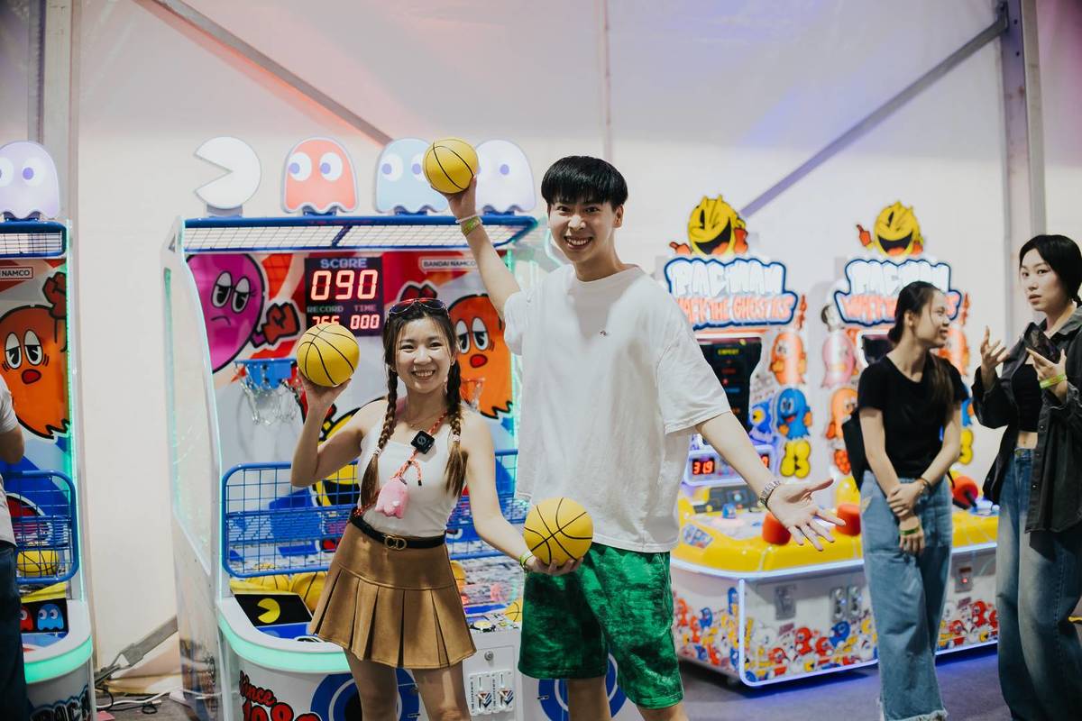 Two guests partaking in the AC9SS: PAC-MAN Carnival games