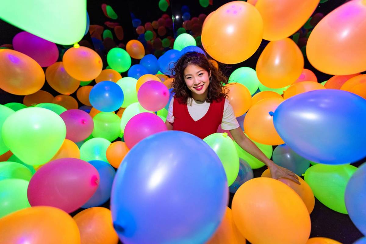 A guest at Dopamine Land Singapore, surrounded by balloons