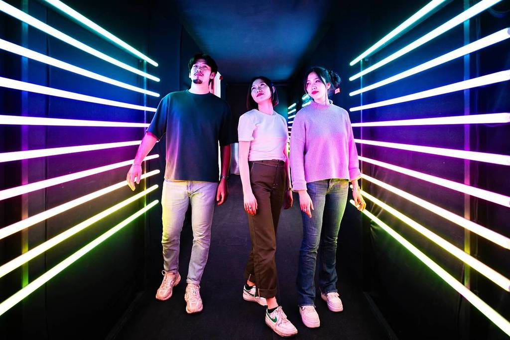 Guests entering Dopamine Land Singapore with neon-lit walls