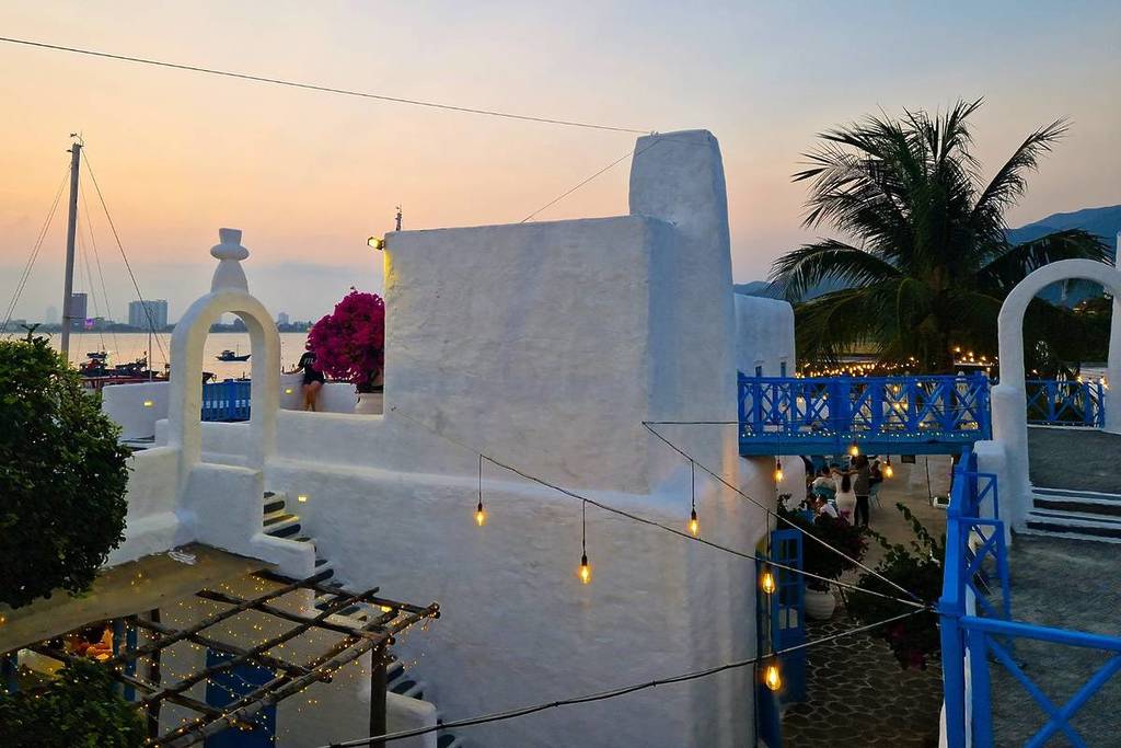 sunset over blue and white dome buildings in Son Tra Marina Da Nang