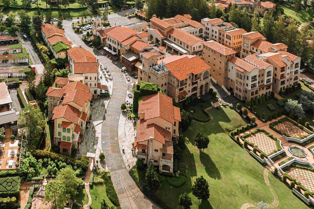 version of Tuscany in Thailand with rolling hills and houses in countryside