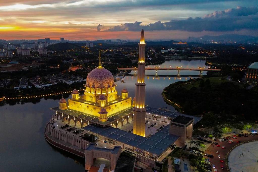 pink mosque glowing at night in Malaysia