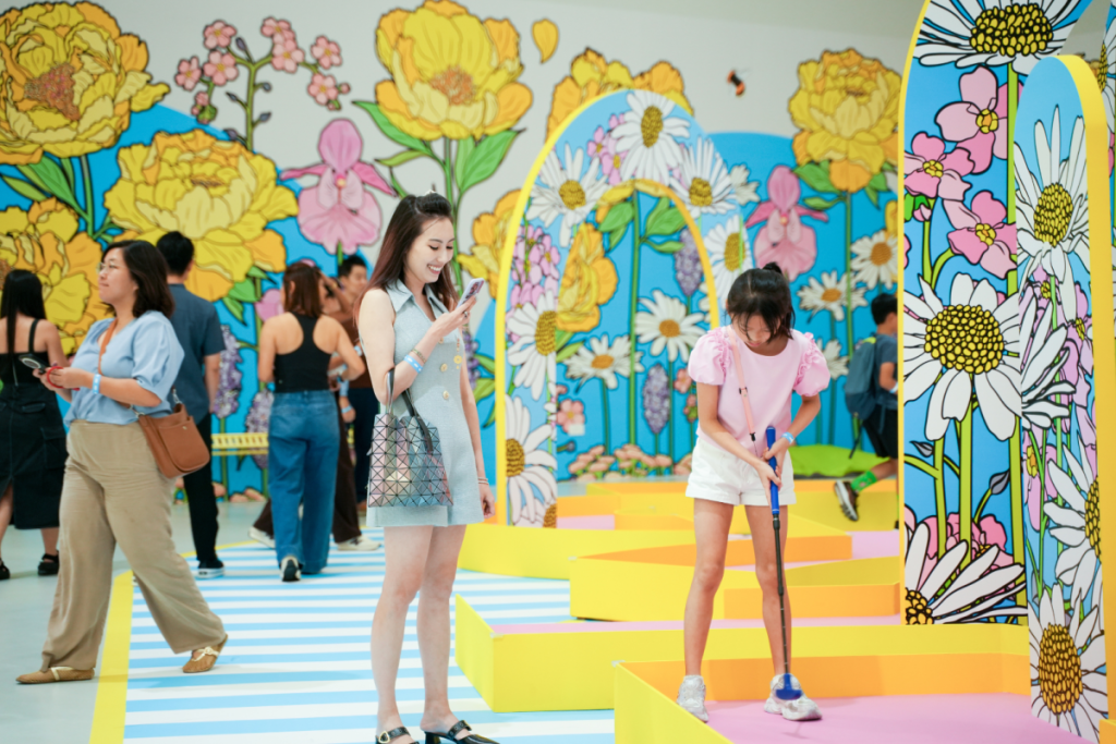 A woman and child playing Mini Golf at IMBA's Bloomyard by Graphic Rewilding