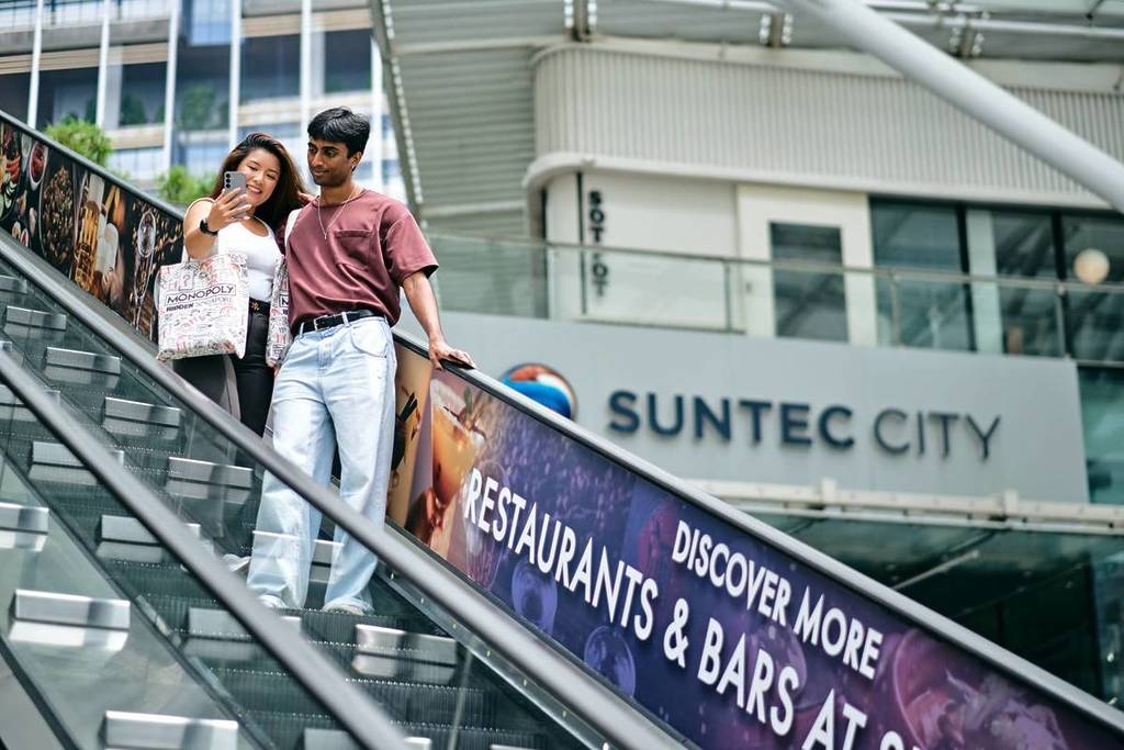 A couple receiving a WhatsApp clues while exploring the hidden side to Suntec City
