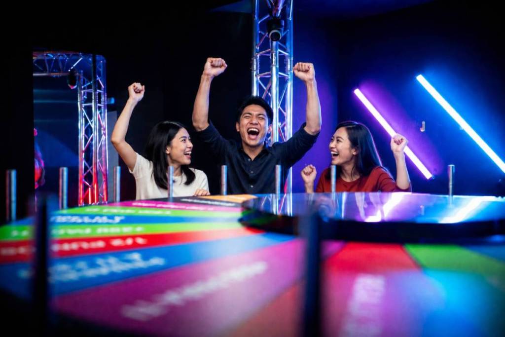 Three BuzzAttack contestants celebrating their Multiplier Wheel victory