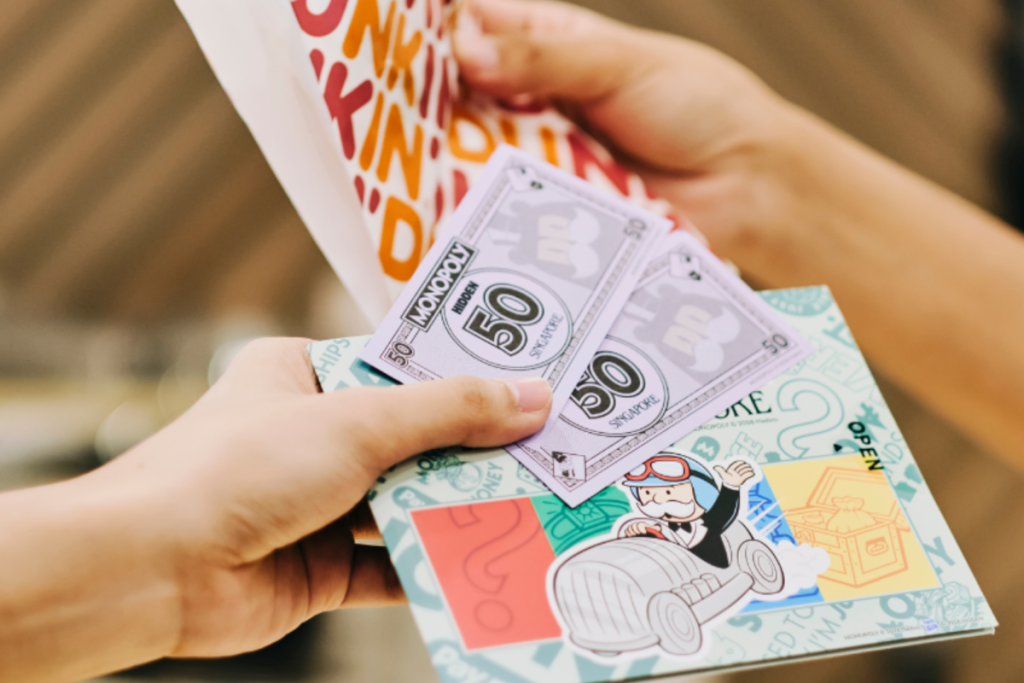 A MONOPOLY: HIDDEN - Holland Village player exchanging M$ for snacks
