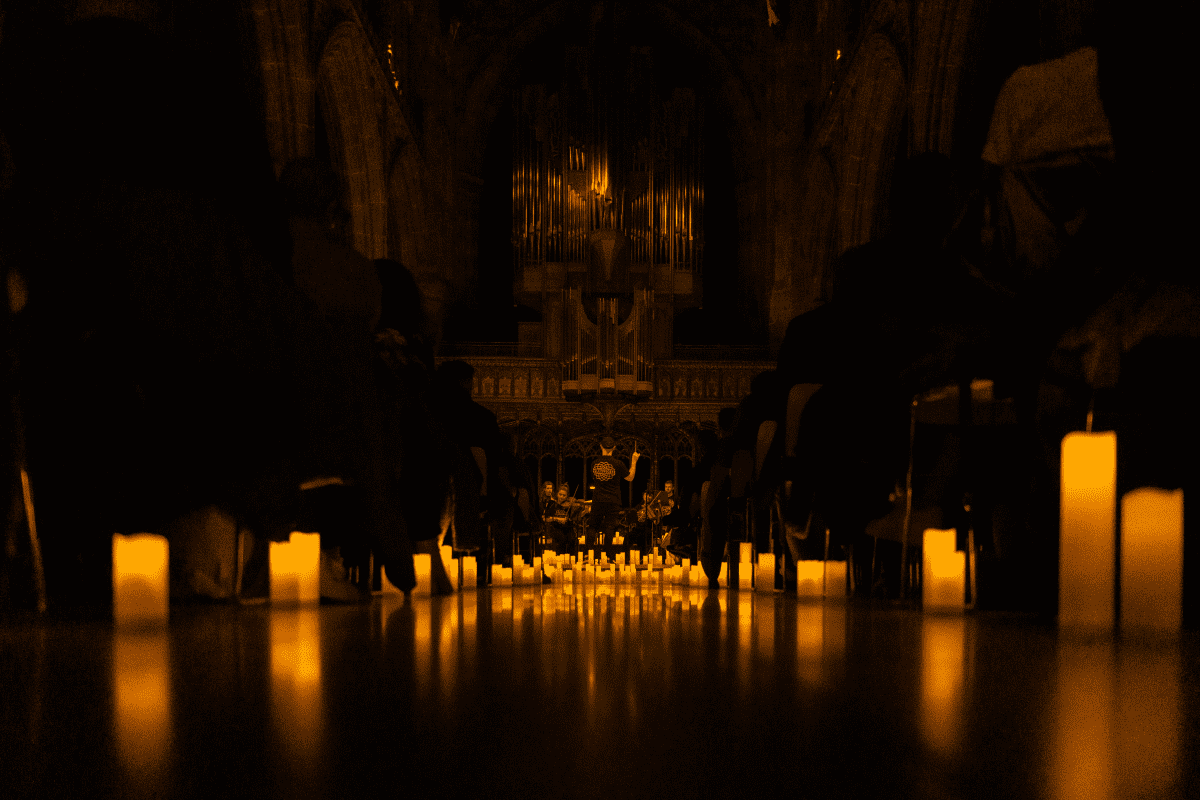 Manchester Cathedral illuminated by candlelight as a full orchestra performs