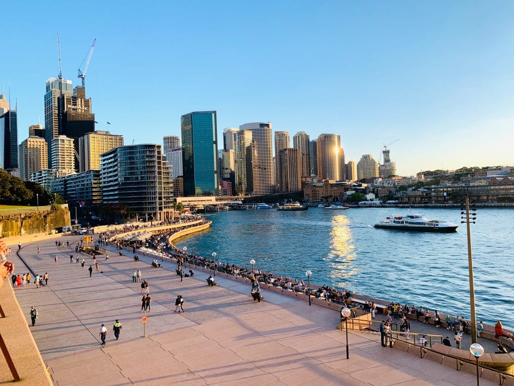 view of sydney city from close to the opera house (not seen) and harbour on the right