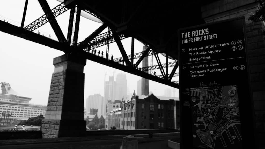 black and white image of sydney from beneath the harbour bridge