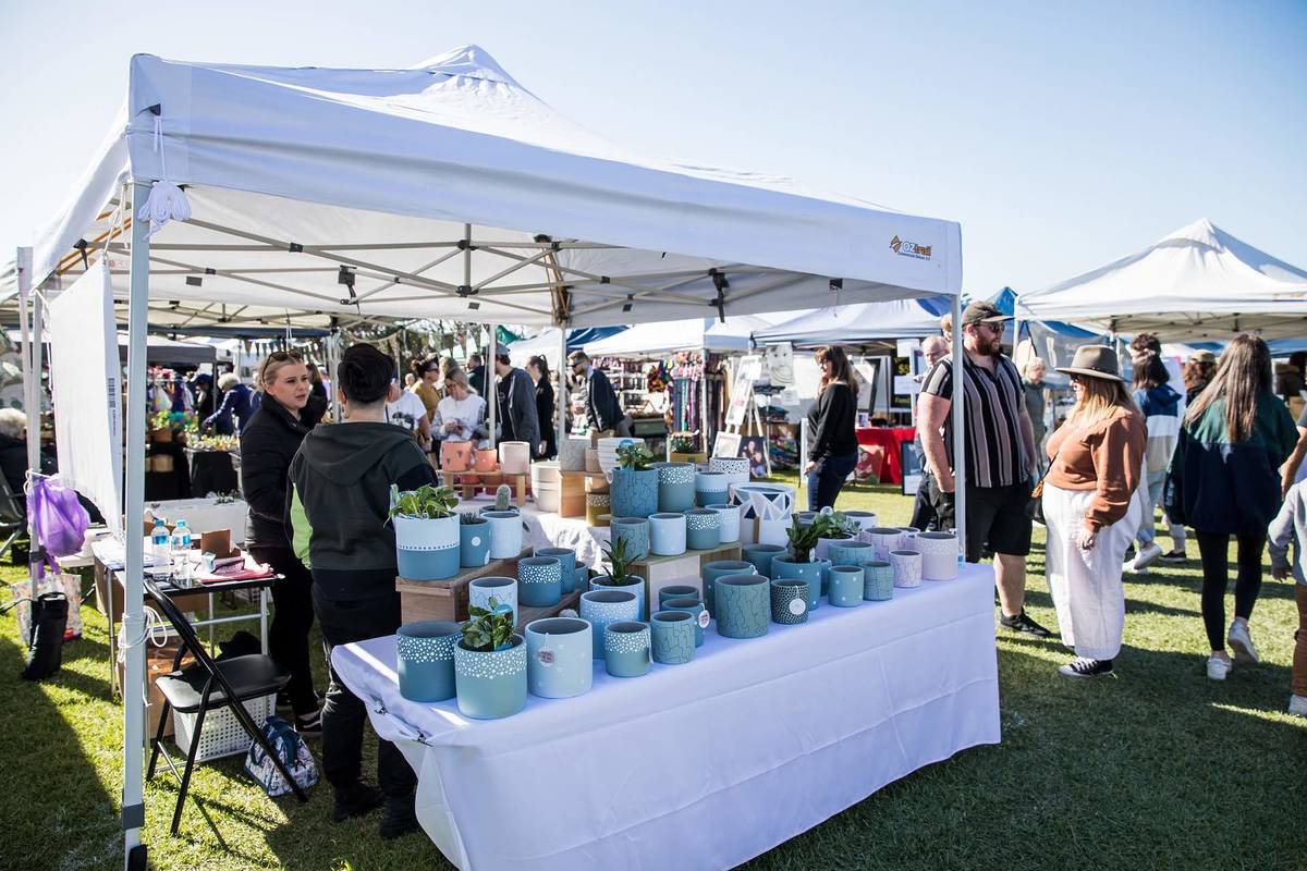 Stalls at Maroubra Beach Markets with handmade ceramics and shoppers browsing outdoors