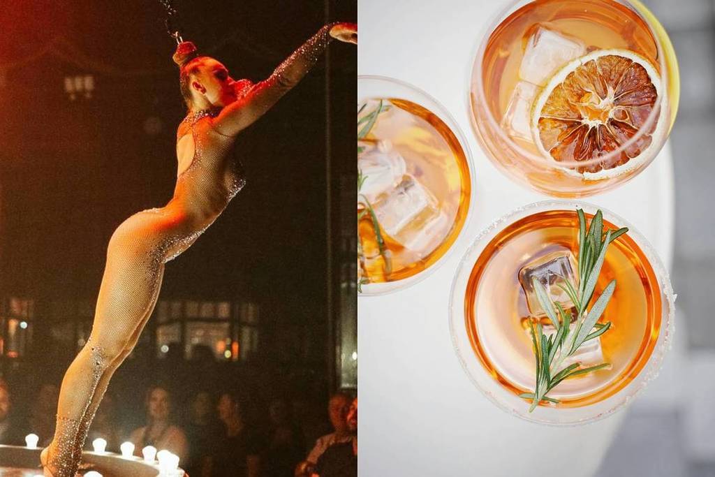 A circus performer on stage and orange cocktails on a table