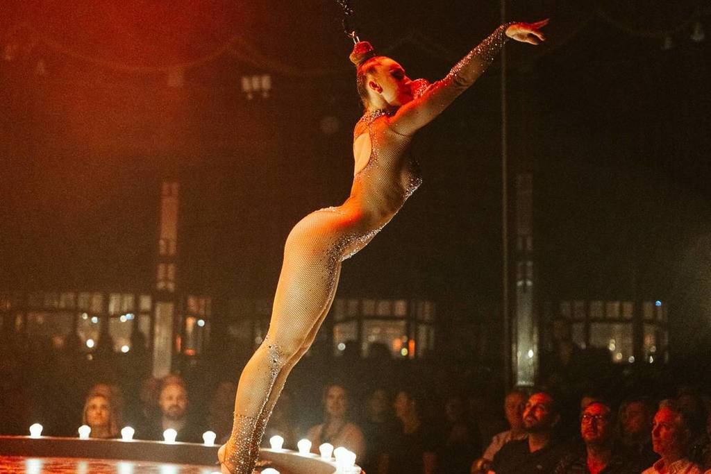 A circus performer leans into the audience at La Ronde.