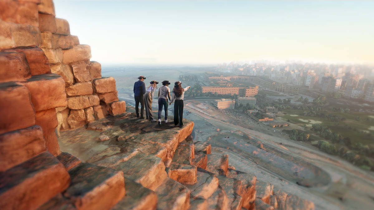 A virtual reality scene of four people standing atop a pyramid landing looking at the view at Horizon of Khufu