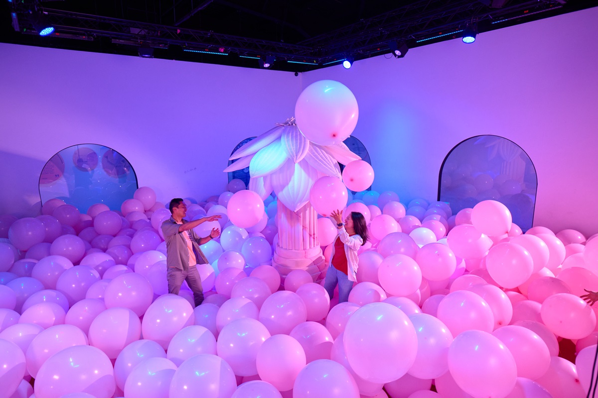 an immersive experiences with large pink bubbles in a purple lit room