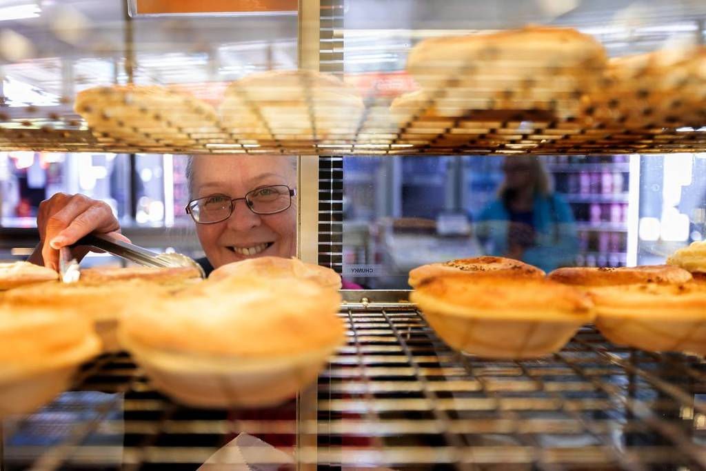 A person looking in at the golden, flaky pies at the Robertson Pie Shop