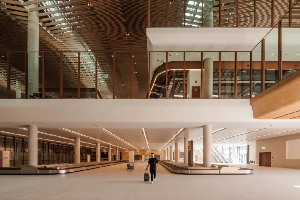 Modern baggage claim area at Western Sydney Airport with sleek timber and glass detailing