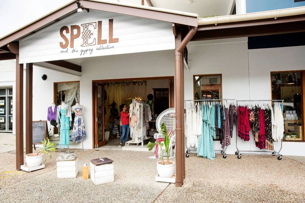 Exterior of Spell boutique in Byron Bay, with racks of colourful boho-style clothing and mannequins displayed outside the entrance