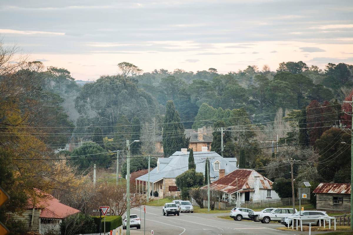 View of Berrima town with historic cottages, tree-lined streets and morning fog on a cold winter day