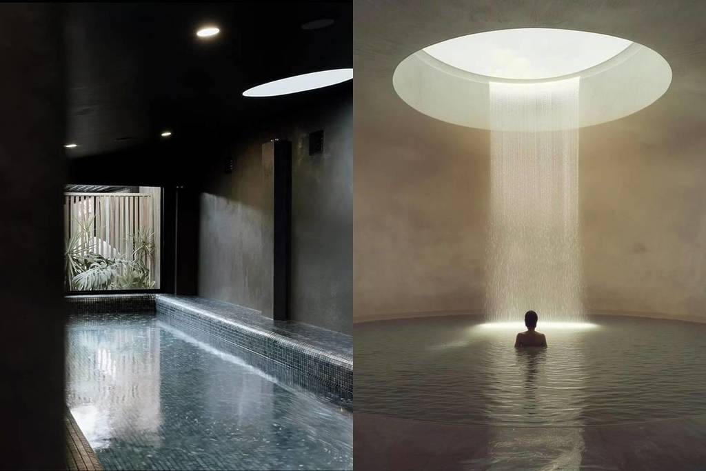 A dimly lit indoor magnesium pool with soft skylight above, paired with a circular space where water cascades from a round skylight into a still pool, surrounding a lone bather at the new Aqua Ignis bathhouse in the Blue Mountains