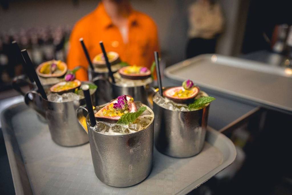 A close up shot of a tray with 6 passionfruit cocktails at Alcotraz.