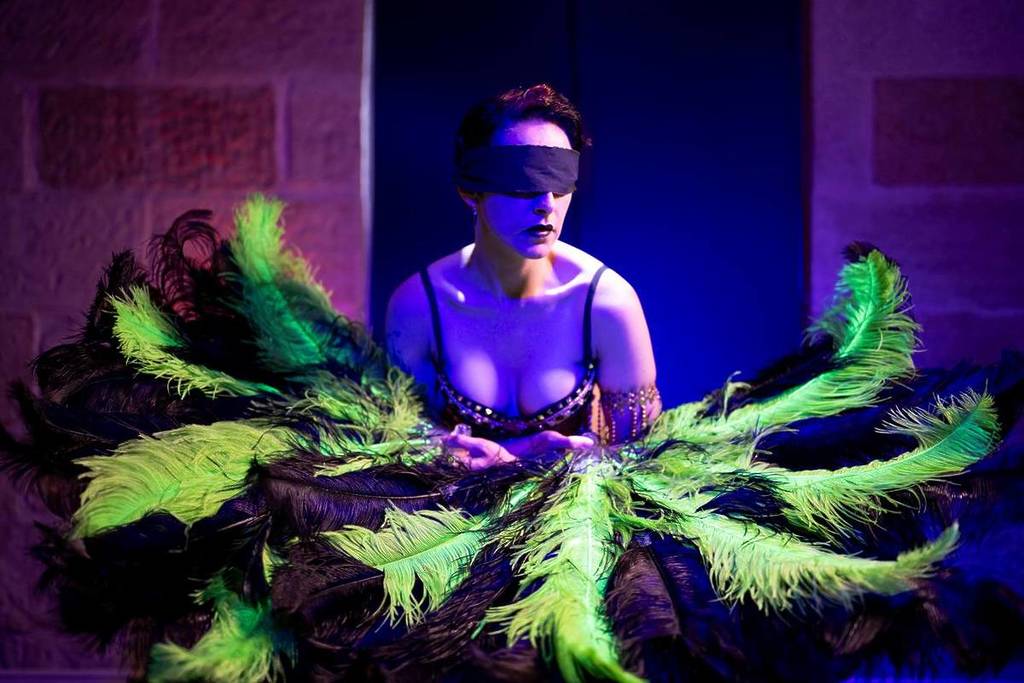A blindfolded performer from When The Night Comes showcasing her stunning costume design