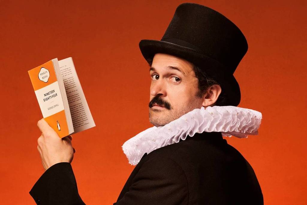 Garry Starr reading Nineteen-Eighty Four in a top hat