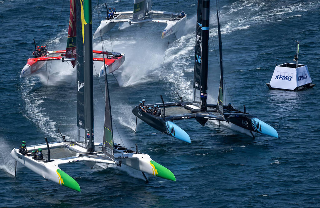 A close up shot of three catamarans on the water, racing in SailGP.