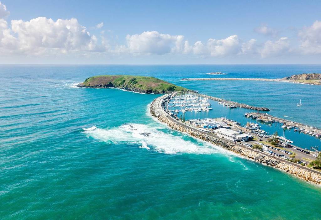 Aerial view of the Coffs Harbour marina, with numerous boats docked along the waterfront