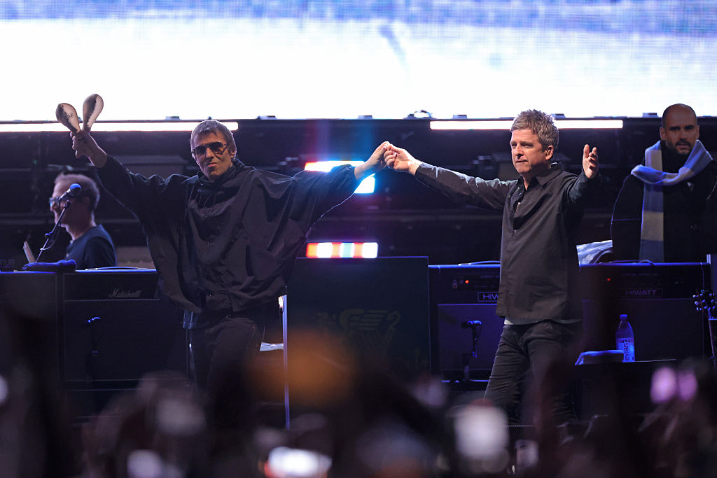 Liam Gallagher and Noel Gallagher walk out together during their Oasis Live ’25 world tour at MetLife Stadium on August 31, 2025 in East Rutherford, New Jersey