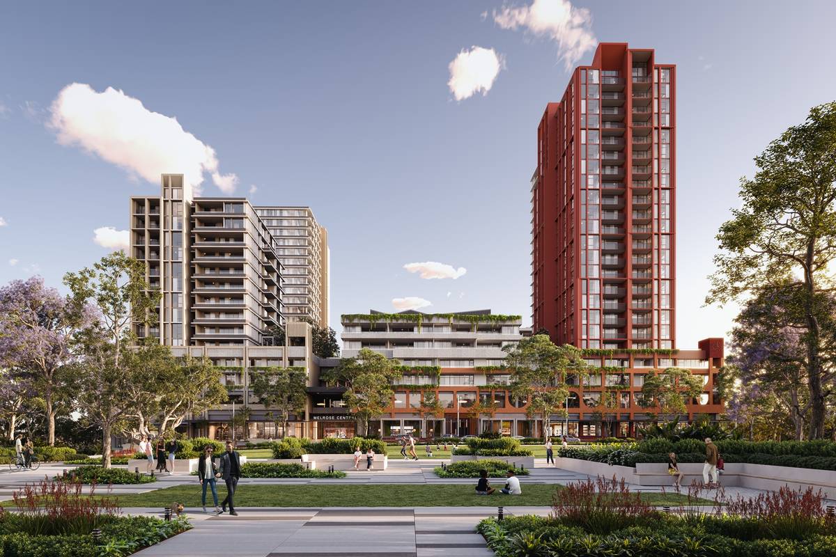 Wide view of Melrose Central in Melrose Park, showing landscaped gardens, people walking, and modern apartment buildings in the background