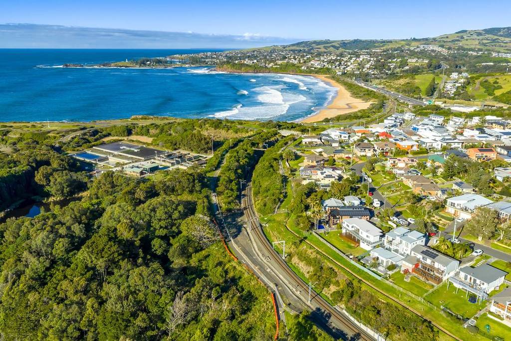 Aerial view of Kiama's coastline with sandy beaches, clear waters, and residential areas nestled along the shore
