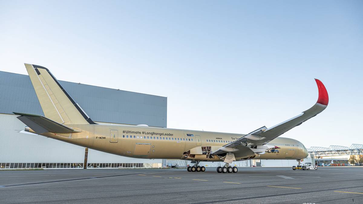 Qantas' Airbus A350-1000ULR being rolled out of the assembly hangar, showing the plane’s nose and tail with a partially painted fuselage