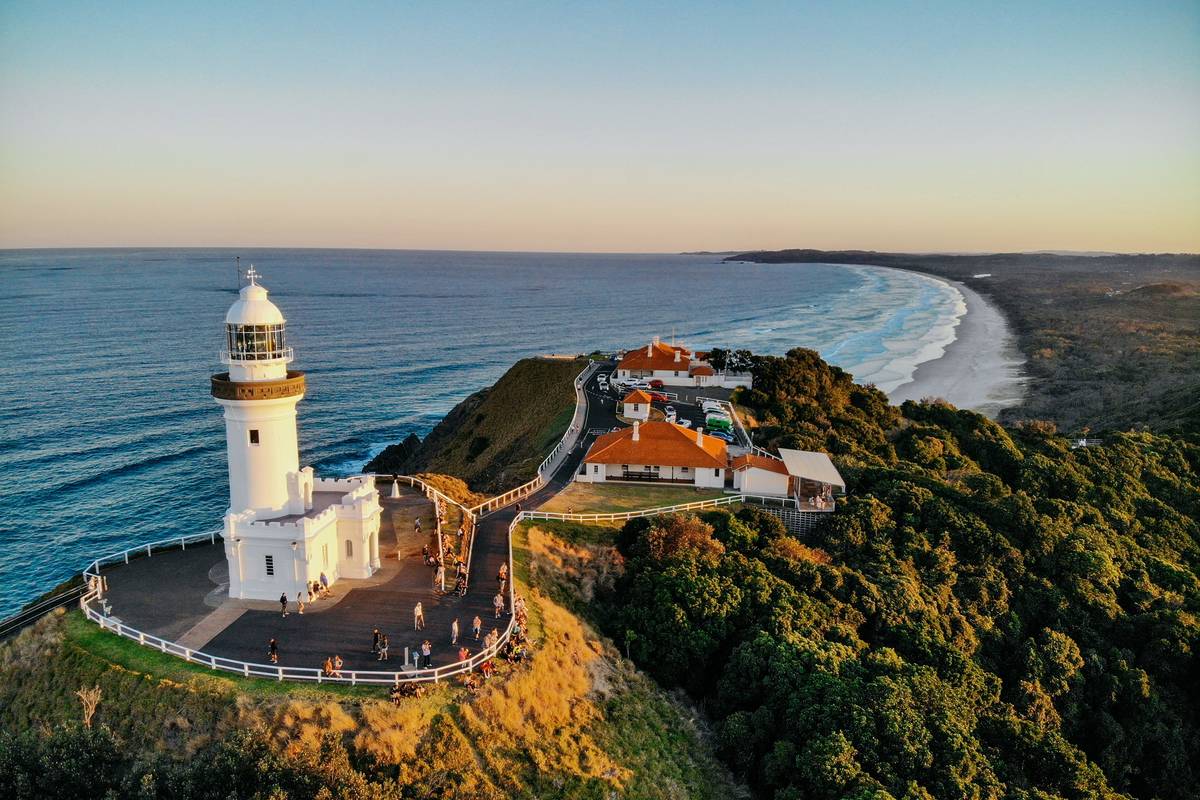 Cape Byron Lighthouse in Byron Bay, NSW, overlooking the coastline and ocean at sunset